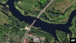 This satellite photo from Planet Labs PBC shows a destroyed bridge across the Seym River at the town of Glushkovo in Russia's Kursk region, Aug. 17, 2024. 