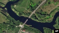 This satellite photo from Planet Labs PBC shows a destroyed bridge across the Seim River at the town of Glushkovo in Russia's Kursk region, Aug. 17, 2024. 