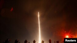 People take pictures during the launch of Boeing-Lockheed joint venture United Launch Alliance&#39;s next-generation Vulcan rocket on its debut flight from Cape Canaveral, Florida.