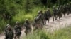 FILE - Japan Ground Self Defense Force members take part in a joint exercise with U.S. Marines on the northern island of Hokkaido, Japan, Aug. 16, 2017. Japan plans to hold joint military exercises with Germany and Spain on the island in June 2024.