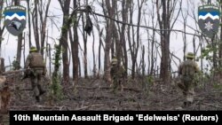 Ukrainian servicemen of the 10th Mountain Assault Brigade 'Edelweiss' fight near Bakhmut, in the Donetsk region of Ukraine, in this screen grab taken from a social media video released May 19, 2023. (10th Mountain Assault Brigade 'Edelweiss'/via Reuters)
