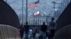 FILE - Pedestrians walk across a footbridge near the border crossing between Mexico and the United States at the San Ysidro border in San Diego, California, U.S., May 29, 2024. 