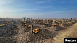 FILE - Graves of Russian Wagner mercenary group fighters are seen in a cemetery near the village of Bakinskaya in Krasnodar region, Russia, Jan. 22, 2023. 