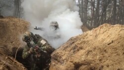 FILE - Ukrainian servicemen take part in radiation, chemical and biological hazard drills, amid Russia's invasion of Ukraine, near Kharkiv, Ukraine Feb. 29, 2024.