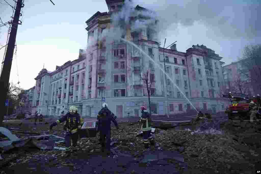 Firefighters work at the site after Russian attacks in Kyiv, Ukraine.