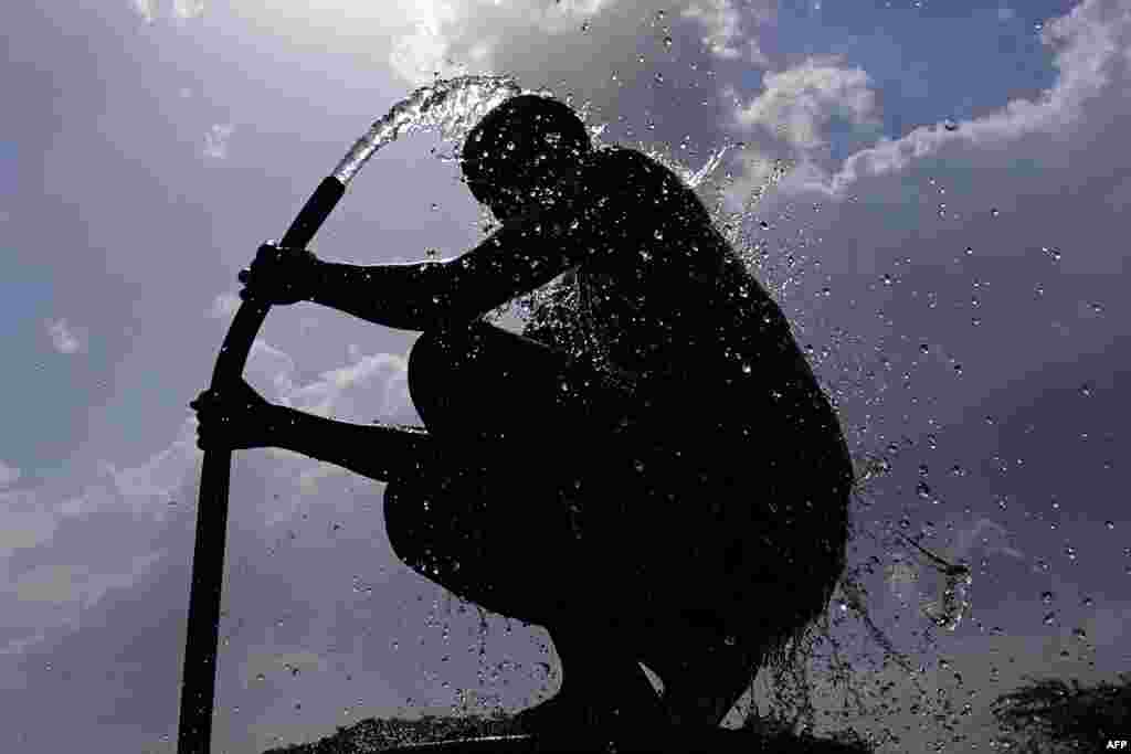 A man is seen as he bathes on a hot summer day at a village on the outskirts of Ajmer, amid the longest heat wave ever to hit India.