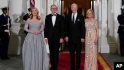 President Joe Biden and first lady Jill Biden welcome Australian Prime Minister Anthony Albanese and his partner, Jodie Haydon, for a state dinner at the White House, Oct. 25, 2023, in Washington.