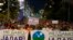 People hold banners reading, "We Won't Give up Jadar!" and march during a protest against pollution and the exploitation of a lithium mine in the country in Belgrade, Serbia, Aug. 10, 2024.