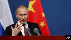 FILE — Russian President Vladimir Putin gestures as he talks with students of the Harbin Institute of Technology in Harbin, northeastern China’s Heilongjiang Province, May 17, 2024.