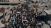 People attend the funeral of four Kurds killed in the town of Jinderis, Syria, March 21, 2023.