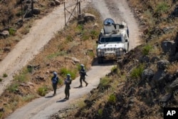 FILE - U.N. peacekeepers (UNIFIL) are seen along the Lebanese side of the border with Israel, July 6, 2023.