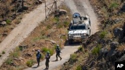 FILE - UN peacekeepers (UNIFIL) seen along the Lebanese side of the border with Israel, seen from Israel, July 6, 2023.