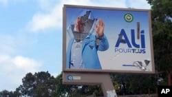 A defaced billboard of Gabon President Ali Bongo Ondimba is seen on an empty street in Libreville, Aug. 30, 2023. Mutinous soldiers said on state television that they had seized power and were overturning the results of the recent presidential election.