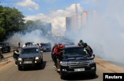 FILE - Riot police fire tear gas to disperse supporters of Kenya's opposition leader Raila Odinga during a nationwide protest over cost of living and President William Ruto's government in Nairobi, March 20, 2023.