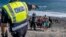 FILE: Migrants, most of them from Morocco, are escorted by Spanish Police after arriving at the coast of the Canary Islands, Spain on Monday, Nov. 23, 2020, after crossing the Atlantic Ocean sailing on a wooden boat.
