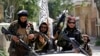 FILE - Taliban fighters display their flag on patrol in Kabul, Afghanistan, Aug. 19, 2021.