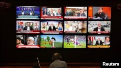 A person watches the news on multiple TV screens, most of them announcing the killing of senior Hamas leader Ismail Haniyeh, in Istanbul, Turkey, July 31, 2024.