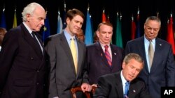 FILE - President George W. Bush signed a $15 billion global AIDS bill May 27, 2003, in Washington. With Bush, from left, were Rep. Tom Lantos, D-Calif., Sen. Bill Frist, R-Tenn., HHS Secretary Tommy Thompson and Secretary of State Colin Powell. 