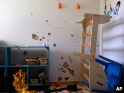 FILE - Bullet holes cover the bedroom wall of hostage Ariel Bibas, 4, in Nir Oz, Israel, on June 21, 2024. Ariel was kidnapped on Oct. 7 with his infant brother, Kfir, his mother, Shiri, and his father, Yarden.