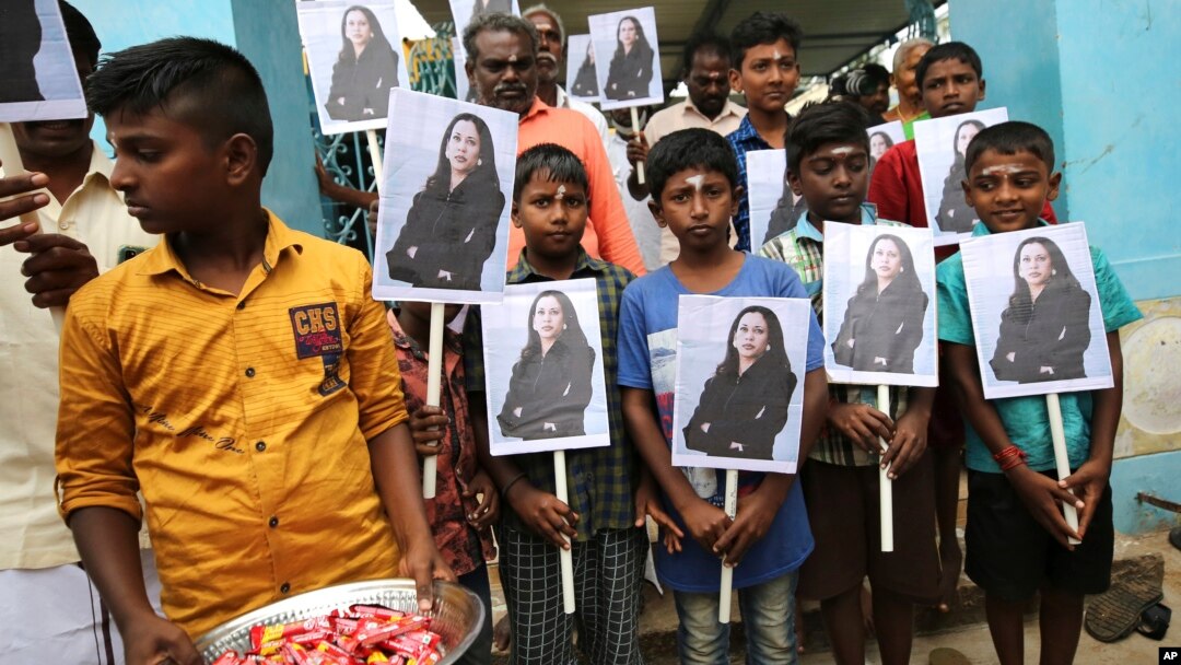 FILE- Ahead of Kamala Harris' inauguration as U.S. vice president, children hold portraits of her at a Hindu temple in Thulasendrapuram, the hometown of Harris' maternal grandfather, south of Chennai, Tamil Nadu state, India, Jan. 20, 2021.