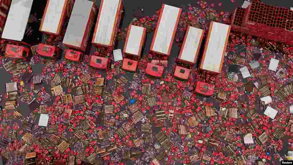 A drone view shows Coca-Cola FEMSA boxes and bottles floating in the water near trucks, amid flooding in Porto Alegre, Rio Grande do Sul state, Brazil, May 19, 2024. 