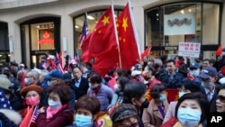 Protesters opposed to Taiwanese independence gather at a hotel where Taiwanese President Tsai Ing-wen was expected to arrive in New York, March 29, 2023.