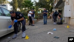 Israeli police inspect the site of a shooting attack in the West Bank Israeli settlement of Ma'ale Adumim, Aug 1, 2023. 