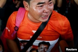 A Move Forward party supporter reacts after Thailand's Constitutional Court delivered its verdict on a case seeking the dissolution of the opposition group over its call for lese-majeste reform, in Bangkok, Aug. 7, 2024.