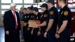 Republican presidential candidate former President Donald Trump delivers pizza to firefighters at Waukee Fire Department in Waukee, Iowa, Jan. 14, 2024.