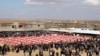 FILE - Coffins with remains of people from the Yazidi minoirty, who were killed by Islamic State militants, and they were exhumed from a mass grave, are seen during the funeral in Kojo, Iraq, Feb. 6, 2021.