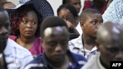 FILE Roseline Asena (L) sits with other relatives of victims of the so-called "Shakahola forest massacre," as they follow court proceedings of the main suspect, self-proclaimed pastor Paul Nthenge Mackenzie, at the Malindi law court, Kilifi county, on May 2, 2023. 