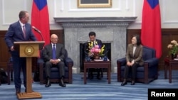 In this screengrab from video, visiting Australian lawmaker Andrew Wallace, left, speaks during a meeting with Taiwanese President Tsai Ing-wen, at the Presidential Office in Taipei, April 9, 2024. To Wallace's right is his colleague Shayne Neumann.