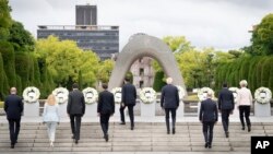 G7 leaders walk together to lay flower wreath, at the cenotaph for Atomic Bomb Victims, ahead of the G7 Summit in Hiroshima, Japan, May 19, 2023.