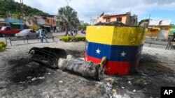 A destroyed statue of the late Venezuelan President Hugo Chavez lays next to its base in Valencia, Venezuela, July 31, 2024. people protested the official election results that certified Chavez's protege, current President Nicolas Maduro, as the winner.