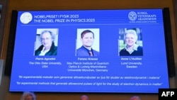 (L-R) US-based physicist Pierre Agostini, Hungarian-Austrian physicist Ferenc Krausz, and French physicist Anne L'Huillier appear on the screen during the announcement of the winners of the 2023 Nobel Prize in Physics in Stockholm on Oct. 3, 2023. 