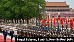 Chinese President Xi Jinping, left, and Russian President Vladimir Putin review the honor guard during an official welcome ceremony in Beijing.