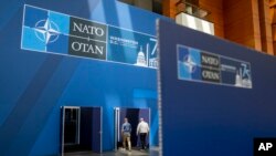 People walk inside the Walter E. Washington Convention Center, which has been decorated with signage in preparation for the NATO summit, July 8, 2024. 