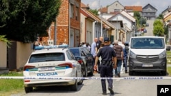 Police and forensics gather near the crime scene in Daruvar, central Croatia, July 22, 2024. 