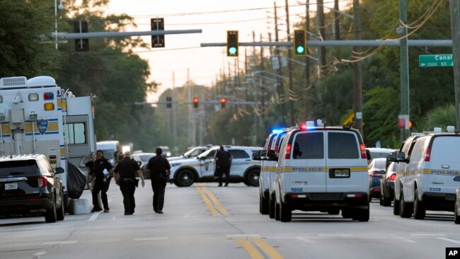 Law enforcement officers investigate the scene of a mass shooting at a Dollar General store, Aug. 26, 2023, in Jacksonville, Flrida.