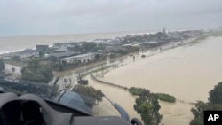 In this image released by the New Zealand Defense Force on Wednesday, Feb. 14, 2023, homes in the Esk Valley, near Napier, New Zealand, are flooded after Cyclone Gabrielle battered the country's north. 
