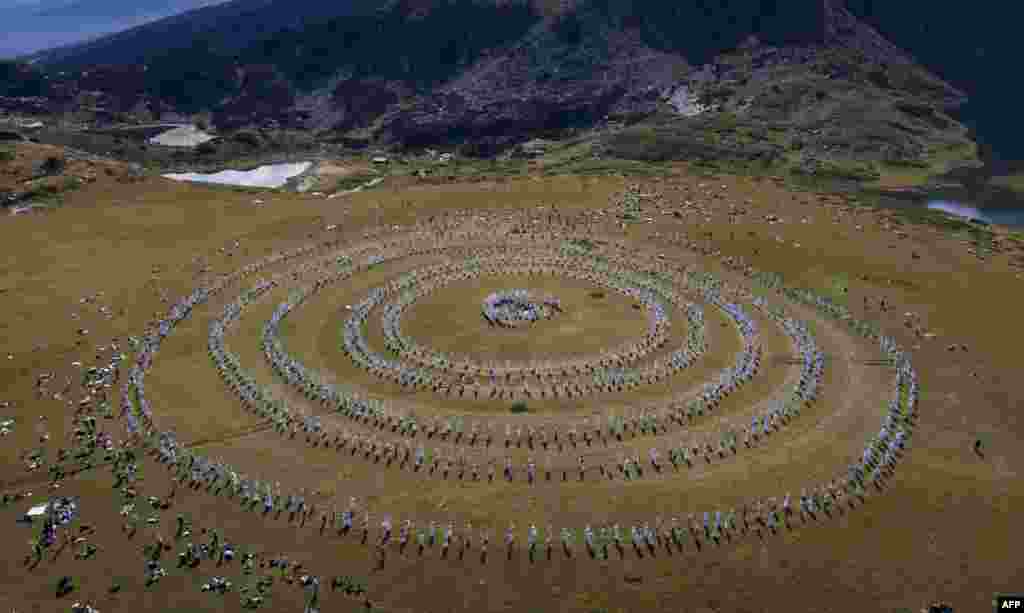 Members of the international religious movement called the White Brotherhood perform ritual dance on the top of the Rila Mountain, near Babreka lake, Bulgaria, Aug. 19, 2023.