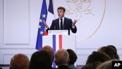 French President Emmanuel Macron gestures as he holds his annual foreign policy speech in front of French ambassadors at the Elysee Palace, in Paris, Aug. 28, 2023.