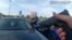 This image from video shows an officer pointing his gun at Ta’Kiya Young moments before shooting her through the windshield, in Blendon Township, Ohio, on Aug. 24. Police pixelated the photo. (Blendon Township police via AP)