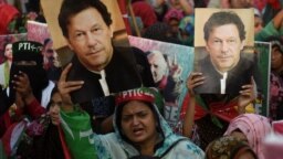 Para pendukung mantan PM Pakistan Imran Khan, membawa plakat dengan potret Imran Khan, selama aksi protes di Karachi hari Minggu, 19 Maret 2023. 