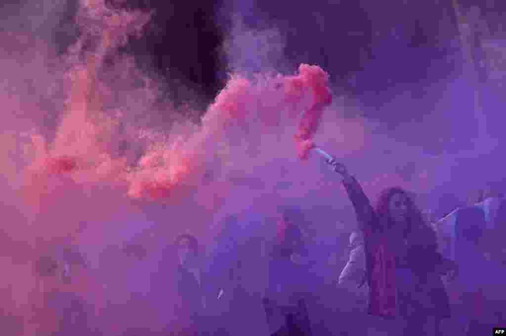 Students attend a demonstration to denounce violence against women, as part of the International Women's Day, in Milan. 