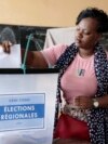 A voter casts her ballot in Togo's regional elections in the capital, Lome, April 29, 2024. 
