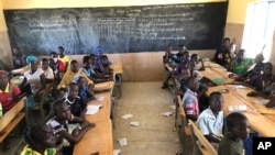FILE - Children gather in a classroom at school in the village of Dori, Burkina Faso, Oct. 20, 2020.