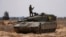 An Israeli tank maneuvers, amid the ongoing conflict between Israel and the Palestinian Islamist group Hamas, near the Israel-Gaza Border, in southern Israel, May 7, 2024. 