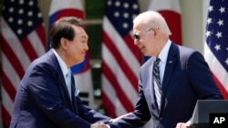 President Joe Biden and South Korea's President Yoon Suk Yeol shake hands during a news conference in the Rose Garden of the White House Wednesday, April 26, 2023, in Washington. (AP Photo/Andrew Harnik)