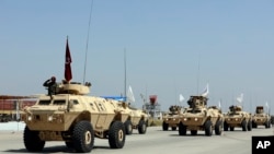 Taliban Military Vehicles are seen during a military parade to mark the third anniversary of the withdrawal of U.S.-led troops from Afghanistan, in Bagram Air Base, Aug. 14, 2024.